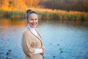 smiling woman by pond