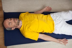 man meditating lying down