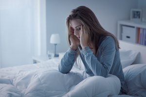 Meditation sickness-woman sitting in bed